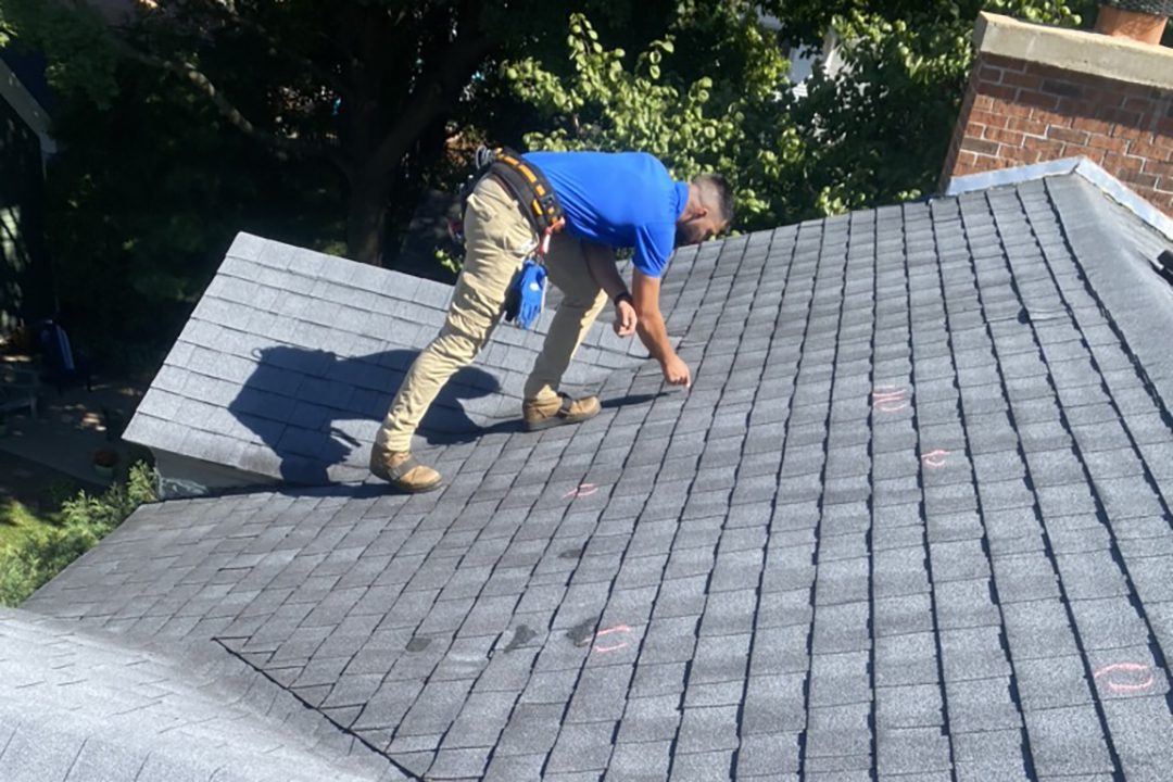 sales rep inspecting a roof